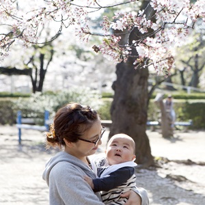 桜の木の下にいる母親と赤ちゃん