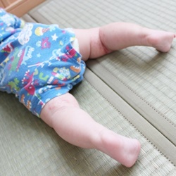 畳の上で寝転ぶ赤ちゃん