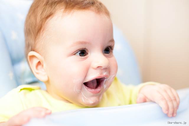 very little kid eats fresh tasty nutritious curds on highchair